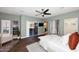 Spacious bedroom with wood-look flooring, ceiling fan, and sliding glass doors leading to the patio at 38820 N 19Th Way, Phoenix, AZ 85086