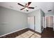 Bedroom with wood-look tile floors, ceiling fan, and sliding closet doors at 38820 N 19Th Way, Phoenix, AZ 85086