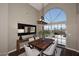 Dining room with a large arched window, wood table, and sliding glass doors to the backyard at 38820 N 19Th Way, Phoenix, AZ 85086