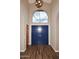 Welcoming entryway with blue double doors, wood-look flooring, and high ceilings with an arched window at 38820 N 19Th Way, Phoenix, AZ 85086