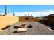 A fire pit with seating and desert landscaping in a backyard at 38820 N 19Th Way, Phoenix, AZ 85086