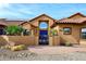 Front exterior of the home showcasing the stucco exterior, tile roof, gated courtyard entry, and desert landscaping at 38820 N 19Th Way, Phoenix, AZ 85086