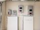 Garage featuring two Tesla Powerwall batteries and other electrical equipment at 38820 N 19Th Way, Phoenix, AZ 85086