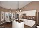 Bright kitchen with white cabinets, dark countertops, and an island at 38820 N 19Th Way, Phoenix, AZ 85086