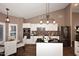 Modern kitchen featuring white cabinets, dark granite countertops, stainless steel appliances, and an island at 38820 N 19Th Way, Phoenix, AZ 85086