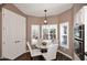 Kitchen nook with round table, white chairs, large window with shutters, and double doors at 38820 N 19Th Way, Phoenix, AZ 85086