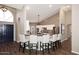 Kitchen with breakfast bar, white barstools, wood-look tile floors, and recessed lighting at 38820 N 19Th Way, Phoenix, AZ 85086