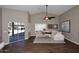 Living room with white sectional sofa, wood-look tile floor, and sliding glass doors to backyard at 38820 N 19Th Way, Phoenix, AZ 85086