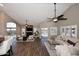 Spacious living room with wood-look tile floors, high ceilings, and plenty of natural light at 38820 N 19Th Way, Phoenix, AZ 85086