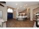 Open-concept living area with a breakfast bar, high ceilings, wood-look flooring, and a view of the kitchen at 38820 N 19Th Way, Phoenix, AZ 85086