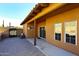 Covered patio with brick flooring and sliding glass doors, leading to the backyard at 38820 N 19Th Way, Phoenix, AZ 85086