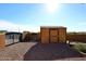Storage shed in the backyard with a gravel pathway and gated entry at 38820 N 19Th Way, Phoenix, AZ 85086