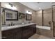 Double vanity bathroom with granite countertops and large mirrors at 15019 N Mayflower Dr, Fountain Hills, AZ 85268