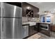 Modern kitchen with granite countertops, stainless steel appliances, and dark wood cabinets at 15019 N Mayflower Dr, Fountain Hills, AZ 85268