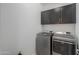 Laundry room with washer, dryer, and dark cabinets at 1619 E Joelle Dr, Casa Grande, AZ 85122