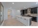 Modern kitchen with dark cabinetry, quartz countertops, and island at 1619 E Joelle Dr, Casa Grande, AZ 85122