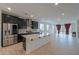 Modern kitchen featuring a large island, stainless steel appliances, and dark cabinetry at 1619 E Joelle Dr, Casa Grande, AZ 85122
