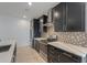 Modern kitchen with dark cabinetry, quartz countertops, and tile backsplash at 1619 E Joelle Dr, Casa Grande, AZ 85122