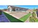 Landscaped backyard with patio, artificial turf, and rockery at 1619 E Joelle Dr, Casa Grande, AZ 85122