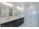Bathroom with double vanity and frameless shower at 1619 E Joelle Dr, Casa Grande, AZ 85122