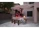 Stone outdoor kitchen with bar seating and pergola at 2311 E Coconino Dr, Chandler, AZ 85249