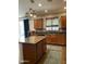 Kitchen island with granite countertop, wood cabinets, and pendant lighting at 2311 E Coconino Dr, Chandler, AZ 85249