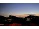 Night view of city lights nestled in the mountains at 10722 N Skyline Dr, Fountain Hills, AZ 85268