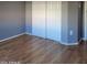 Bright bedroom with wood flooring and double closets at 11515 W Sandsnake Ct, Surprise, AZ 85378