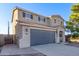 Two-story house with gray garage and landscaping at 38318 N La Grange Ln, San Tan Valley, AZ 85140