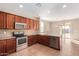 Kitchen with island, stainless steel appliances, and access to backyard at 38318 N La Grange Ln, San Tan Valley, AZ 85140