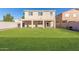Spacious backyard with grassy area and covered patio at 38318 N La Grange Ln, San Tan Valley, AZ 85140