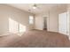 Bedroom with carpet, ceiling fan, and access to bathroom at 38318 N La Grange Ln, San Tan Valley, AZ 85140