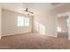 Bright bedroom with carpet, ceiling fan and large window at 38318 N La Grange Ln, San Tan Valley, AZ 85140