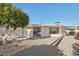 Rear view of house showing patio and citrus trees at 10623 W El Rancho Dr, Sun City, AZ 85351