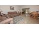 Living room with tile flooring, brown couches and dining area at 13027 N 111Th Ave, Sun City, AZ 85351