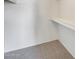 Closet with white shelves and carpeted floor at 222 W Brown Rd # 117, Mesa, AZ 85201
