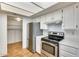 Stainless steel appliances and white cabinetry in this kitchen at 222 W Brown Rd # 117, Mesa, AZ 85201