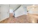 Bright living room with tile floors and view to kitchen and staircase at 222 W Brown Rd # 117, Mesa, AZ 85201