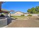 Backyard with covered patio, grass, and gravel area at 4175 S Marisol Ln, Gilbert, AZ 85297