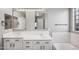 Bathroom with double vanity, white cabinets, and subway tile at 4175 S Marisol Ln, Gilbert, AZ 85297