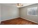 Bright bedroom with wood-look floors and ceiling fan at 4175 S Marisol Ln, Gilbert, AZ 85297