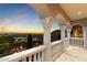 Balcony with decorative columns, overlooking a picturesque cityscape at sunset at 6105 E Sage Dr, Paradise Valley, AZ 85253