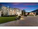 Home's exterior at dusk with landscaped yard and paver driveway at 6105 E Sage Dr, Paradise Valley, AZ 85253