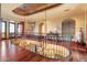 Second-floor hallway with hardwood floors, chandelier, and decorative railing at 6105 E Sage Dr, Paradise Valley, AZ 85253