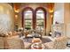 Elegant living room with arched windows, fireplace, and mountain views at 6105 E Sage Dr, Paradise Valley, AZ 85253