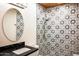 Bathroom with patterned tile shower and a modern vanity at 6237 E Pinchot Ave, Scottsdale, AZ 85251