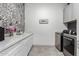 Laundry room with washer, dryer, and stylish tile backsplash at 30927 N 117Th Dr, Peoria, AZ 85383