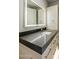 Contemporary bathroom with dark countertop and illuminated mirror at 4880 E Lone Mountain N Rd, Cave Creek, AZ 85331