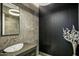 Elegant bathroom boasts a sleek design with dark-colored wall paneling and a vessel sink at 4880 E Lone Mountain N Rd, Cave Creek, AZ 85331