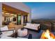 Covered patio features fire pit, comfortable seating, and mountain views at 4880 E Lone Mountain N Rd, Cave Creek, AZ 85331